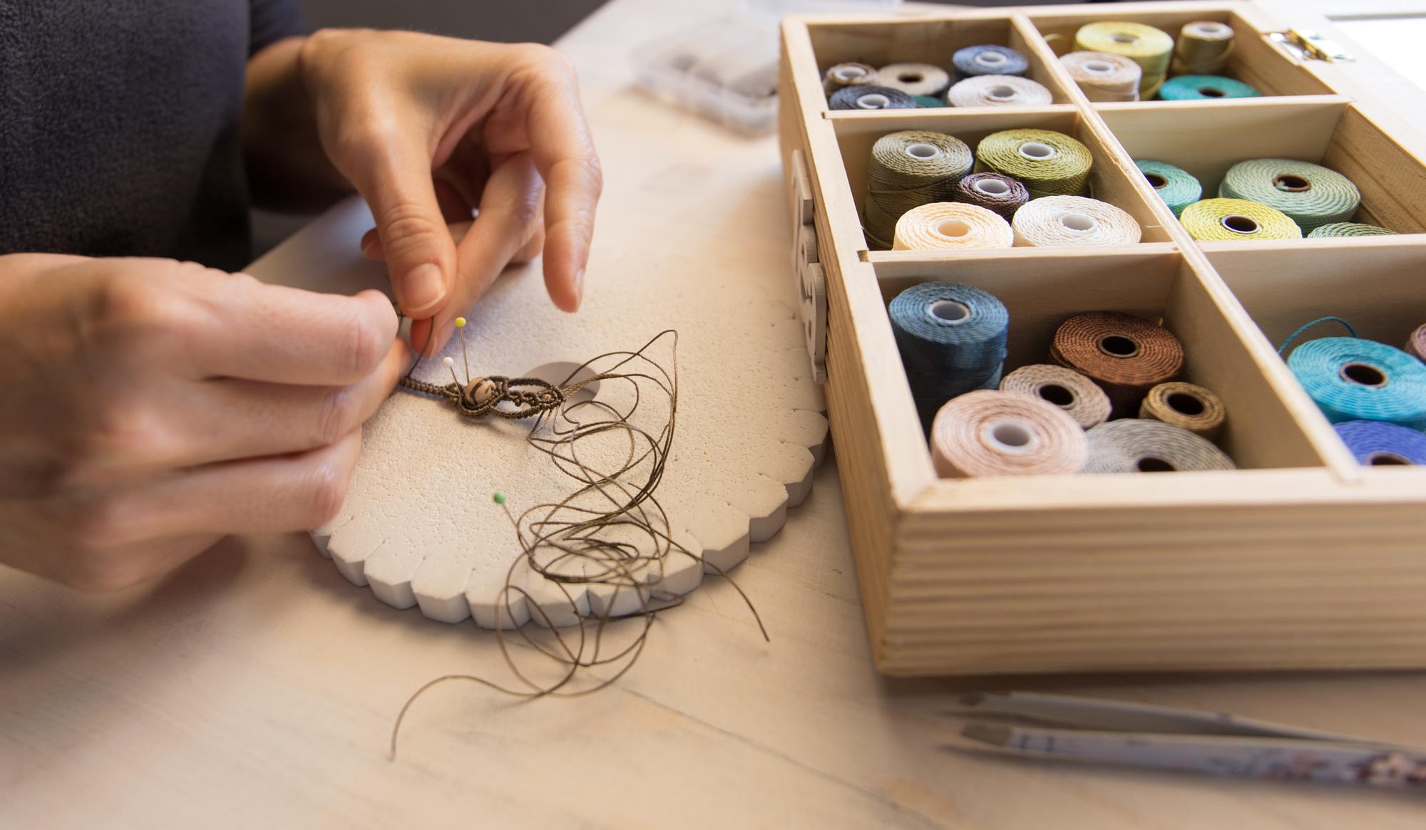 artisan hands preparing embroidery thread